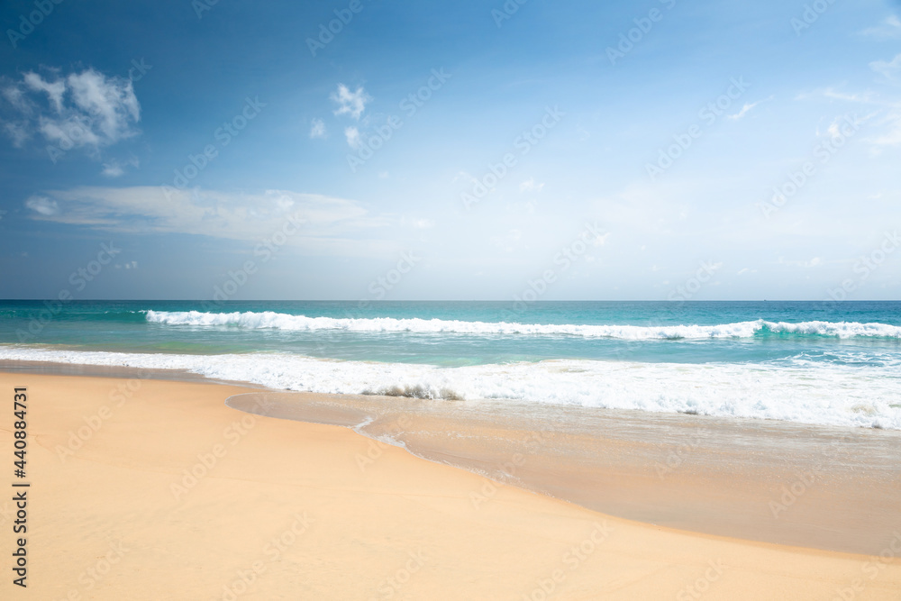 Empty summer beach, on a sunny day with blue sky, and white clouds Sea sand beach, with the soft wave moving to the shore, and beautiful sky with cloud, on the summer season of Thailand.