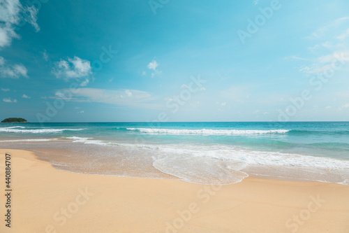 Empty summer beach  on a sunny day with blue sky  and white clouds Sea sand beach  with the soft wave moving to the shore  and beautiful sky with cloud  on the summer season of Thailand.