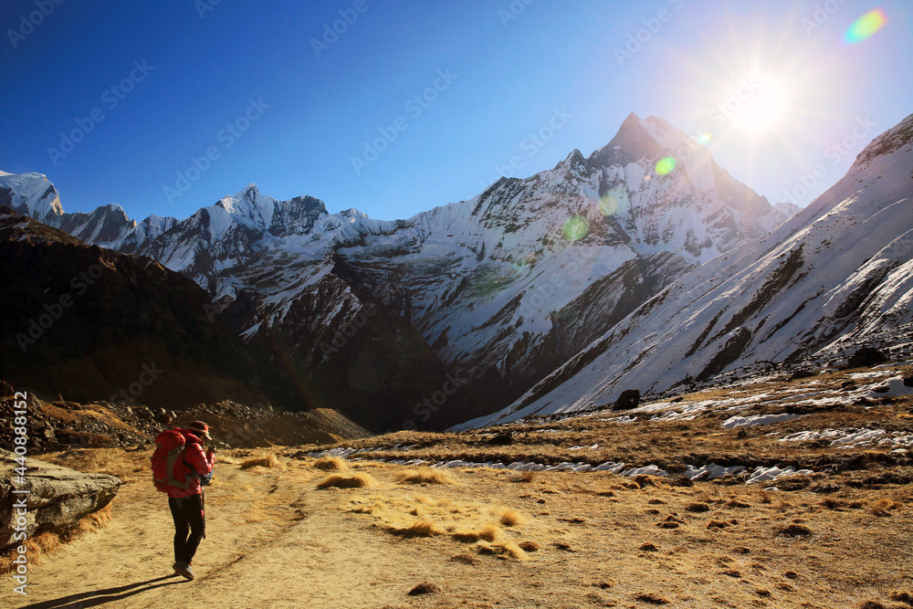 Female hikers climbing the snow-covered Himalayas in winter.