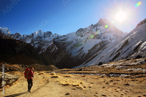 Female hikers climbing the snow-covered Himalayas in winter.