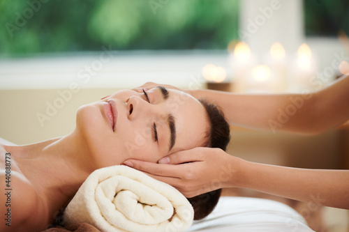 Bilde på lerret Close-up of pretty woman lying on bed and getting massage from therapist