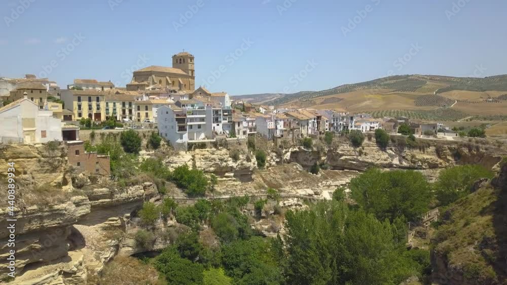 Aerial view of white houses on the edge of a canyon in the town of Alhama de Granada, Andalusia, Spain. Aerial view of white houses on the edge of a canyon in the town of Alhama de Granada, Andalusia, Spain.