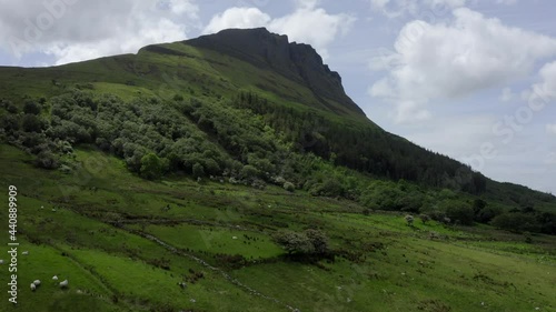 Benwiskin Mountain Sligo, Ireland, June 2021. Drone ascends the western face flying over stoney fields, craggy hillsides and leafy woodland. photo
