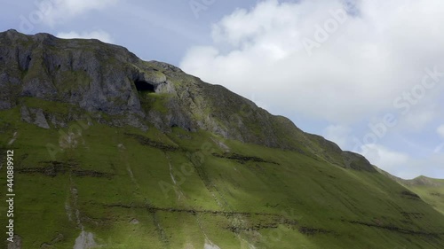 Diarmuid and Grainne's cave in Sligo, Ireland, June 2021. Drone gradually orbits around the base of the Gleniff Horseshoe mountains facing north-west looking up at the cliffs of Annacuna. photo