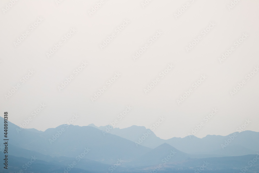 Mountains silhouette in the morning haze, copy space, Greece.
