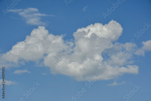 Beautiful cumulus clouds against the blue daytime sky.