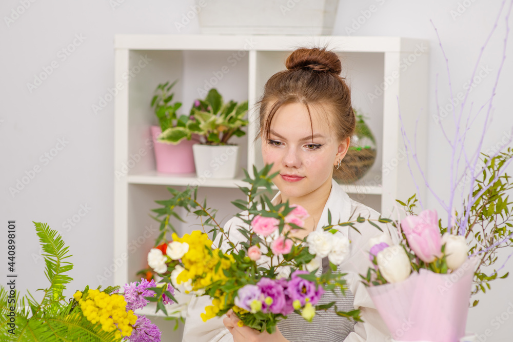 Floristics, business, decoration concept. Female sales assistant working as florist standing behind counter