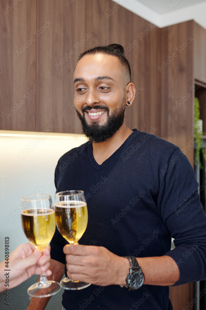 Portrait of handsome bearded man clinking glasses with girlfriend when they are celebrating anniversary at home Portrait of handsome bearded man clinking glasses with girlfriend when they are celebrating anniversary at home