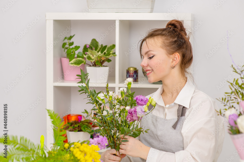 Smiling Woman Florist Small Business Flower Shop Owner. Happy woman gardener with flower Smiling Woman Florist Small Business Flower Shop Owner. Happy woman gardener with flower