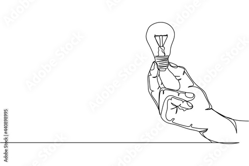 Continuous one line of close up hand holding light bulb in silhouette on a white background. Linear stylized.Minimalist.