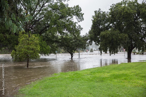 Road under water from extreme weather flooding in rural town