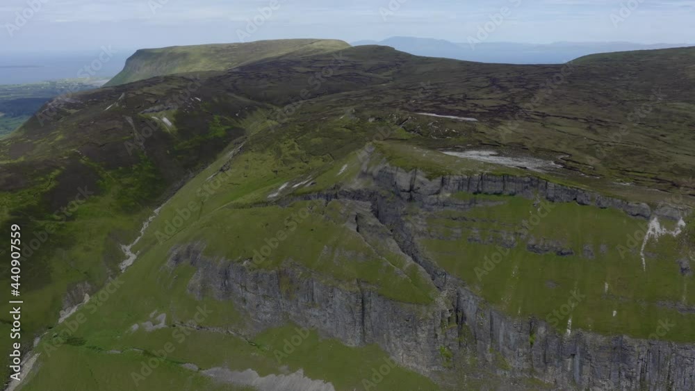 Kings Mountain, Sligo, Ireland, June 2021. Drone slowly orbits the summit of the southern face with Benbulbin and Sligo Bay in the background.