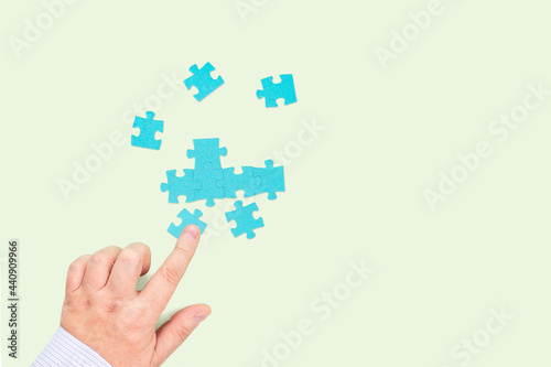 Businessman connecting puzzle pieces