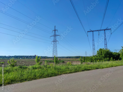 Road in the field under the power line