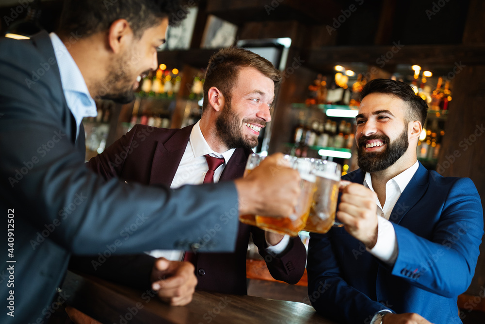 People, men, leisure, friendship and celebration concept. Happy male friends drinking beer at pub People, men, leisure, friendship and celebration concept. Happy male friends drinking beer at pub