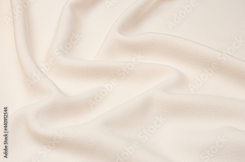 Smooth elegant ivory tissue abstract background. Textile background. Cloth wallpaper. Graphics design element