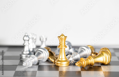 The gole queen chess surrounded by chess pieces , business strategy