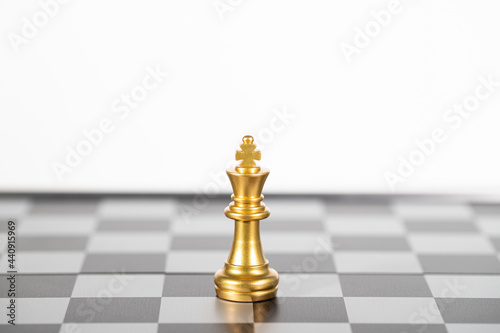The gold king chess alone on the chess board , business strategy