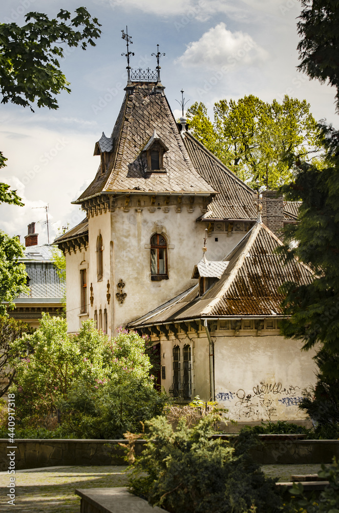 Beautiful old house, handsome mansion surrounded by green trees, baroque architecture style, ancient house with small tower Beautiful old house, handsome mansion surrounded by green trees, baroque architecture style, ancient house with small tower