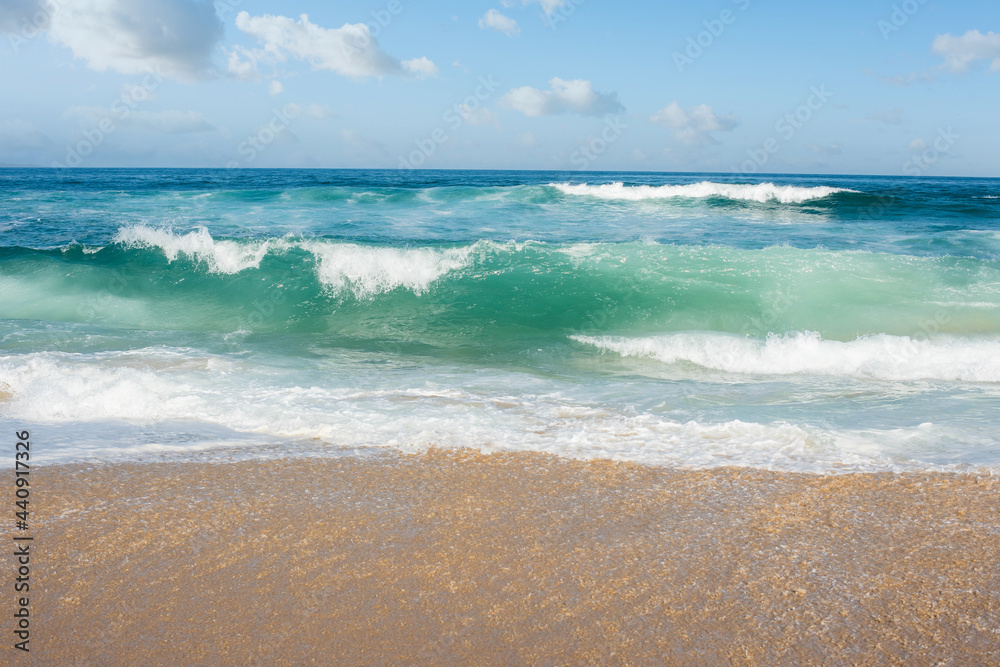 waves falling on the sunny beach