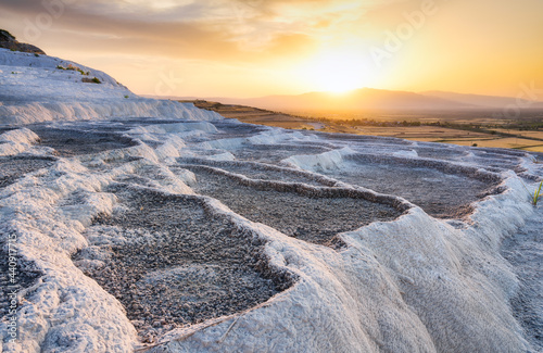 Summer landscape during sunset. The view of the travertines and the bright su...