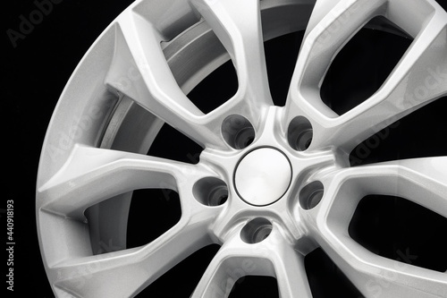 close-up of the car alloy wheel detail in gray on a black background