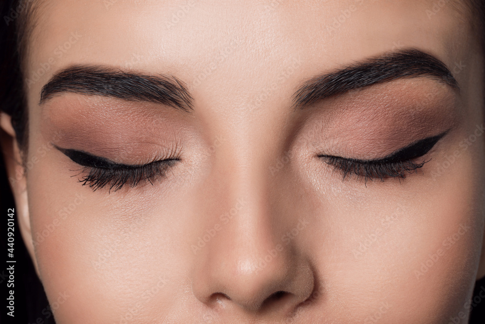 Beautiful woman with black eyeliner, closeup view Beautiful woman with black eyeliner, closeup view