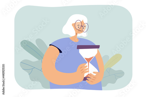 Sad old woman holding hourglass. Elderly character watching time pass flat vector illustration. Time management, age, lifespan, retirement concept for banner, website design or landing web page