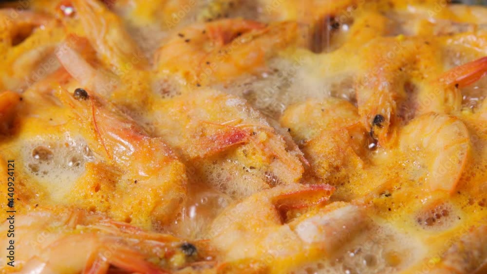 Grilled fresh shrimps fried in pan with butter or oil. Frying raw prawns. Grilled fresh shrimps fried in pan with butter or oil. Frying raw prawns.