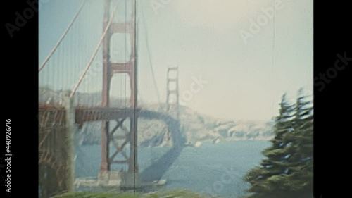 Archival seventies footage, point of view of vintage car crossing Golden Gate Bridge from Presidio Pacific point to the north. 1970s Archival of California, United States of America in 1976. photo