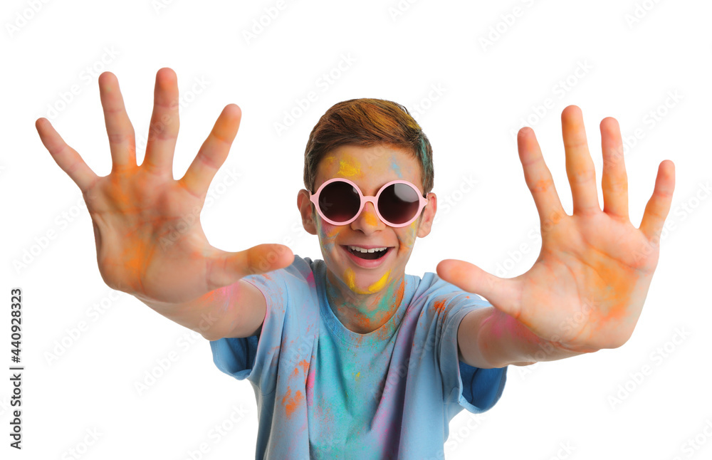 Naklejka premium Teen boy covered with colorful powder dyes on white background. Holi festival celebration