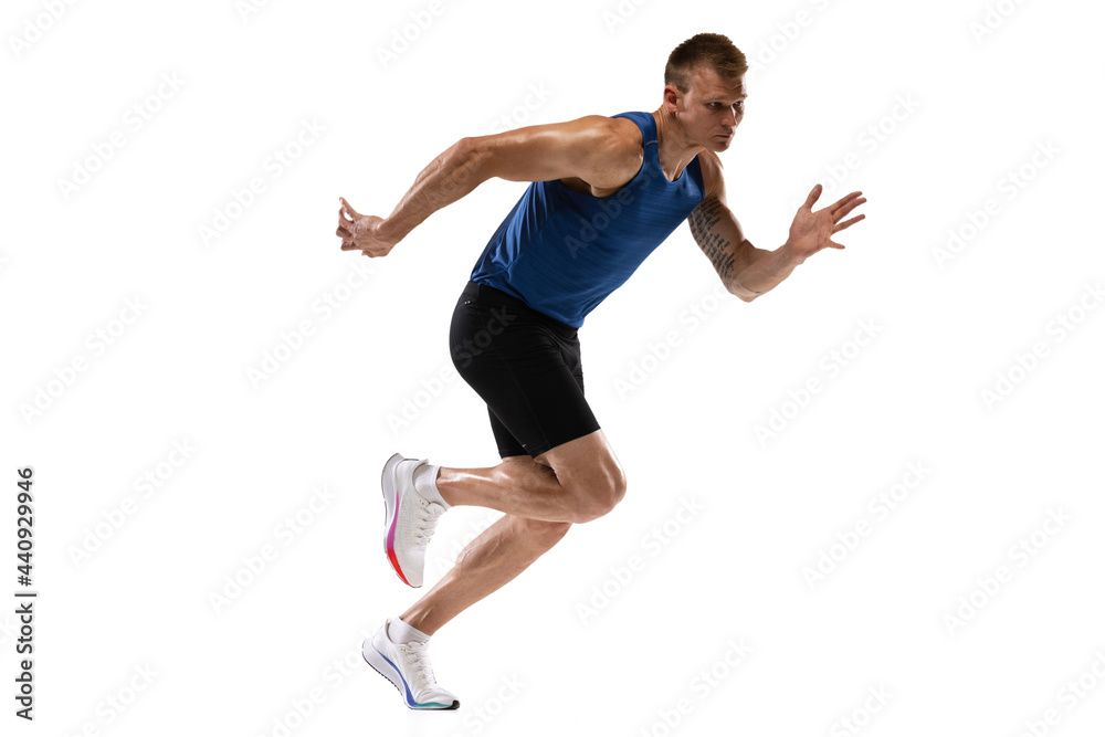 Fototapeta Caucasian professional male athlete, runner training isolated on white studio background. Muscular, sportive man. Concept of action, motion, youth, healthy lifestyle. Copyspace for ad.