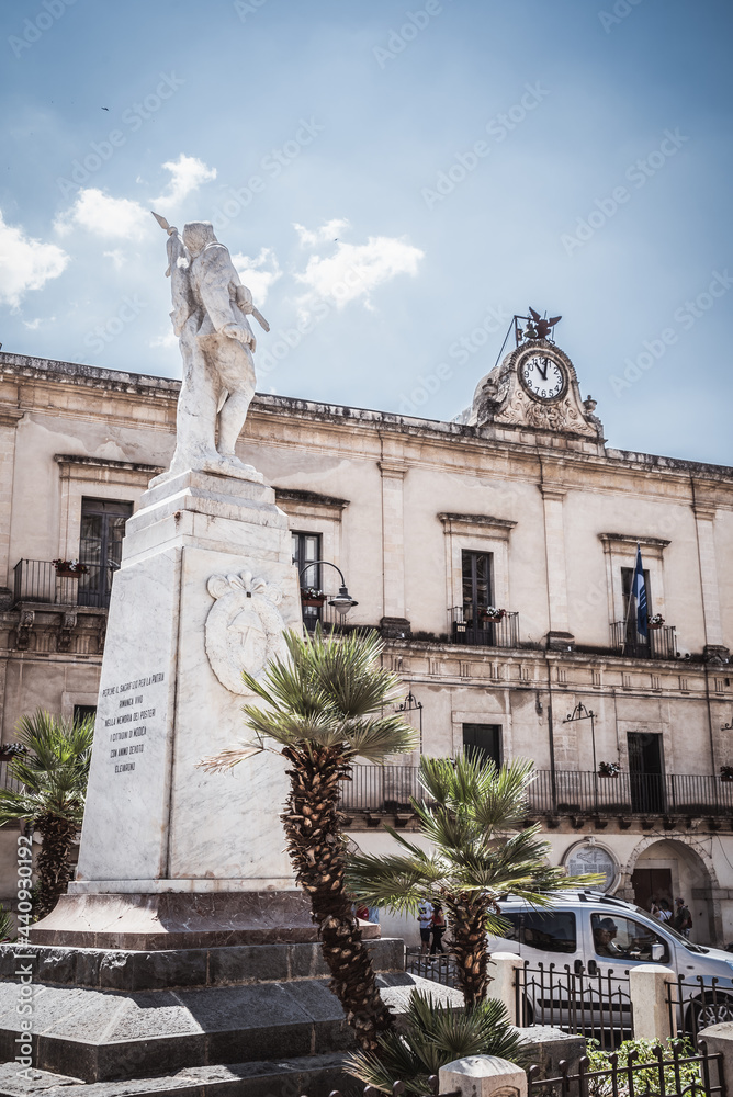 Obraz premium WW2 Memorial with Modica City Hall in the Background, Ragusa, Sicily, Italy, Europe, World Heritage Site