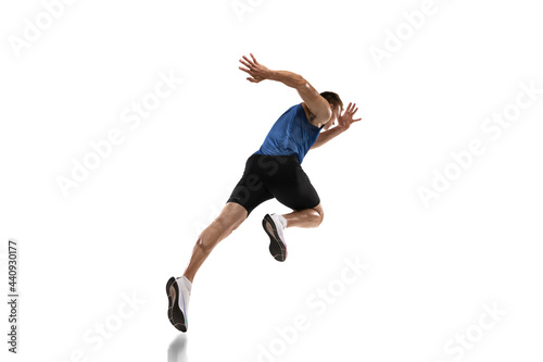 Caucasian professional male athlete, runner training isolated on white studio background. Muscular, sportive man. Concept of action, motion, youth, healthy lifestyle. Copyspace for ad.