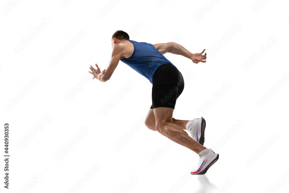 Caucasian professional male athlete, runner training isolated on white studio background. Muscular, sportive man. Concept of action, motion, youth, healthy lifestyle. Copyspace for ad.