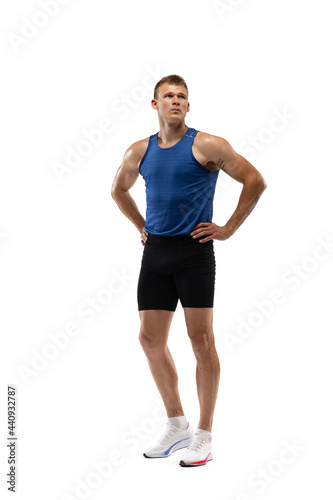 Caucasian professional male athlete, runner standing isolated on white studio background. Muscular, sportive man. © master1305