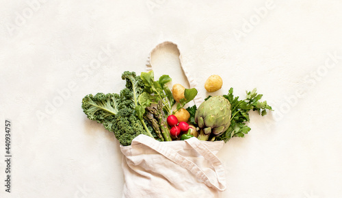 Close up view of the textile eco bag with fresh season vegetables