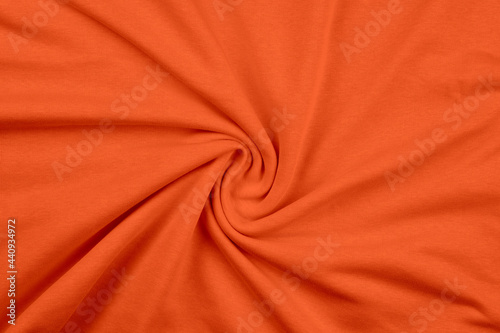 Background from orange monochrome cotton fabric. Close up texture of the fabric is useful as a background. photo