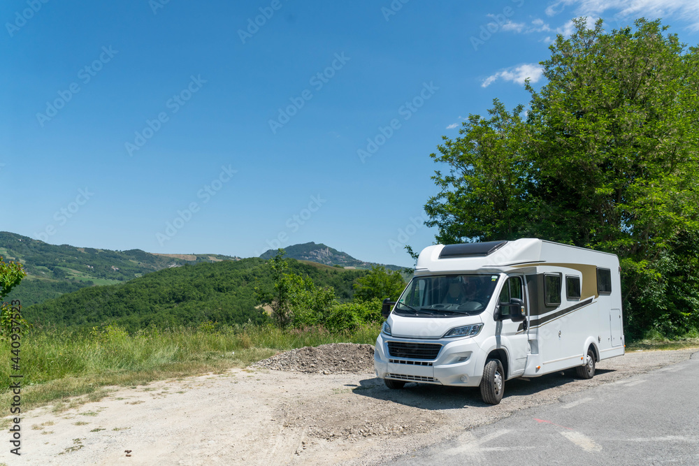 Campervan on deserted place with view on the Italian mountains