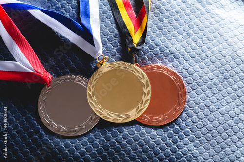 Gold, silver and bronze medal on velvet cushion photo
