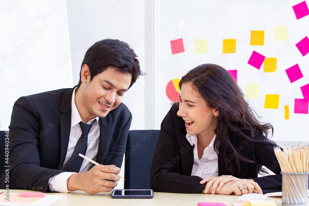 Asian and caucasian ethnicity partnership businesspeople discuss a business plan together Asian and caucasian ethnicity partnership businesspeople discuss a business plan together