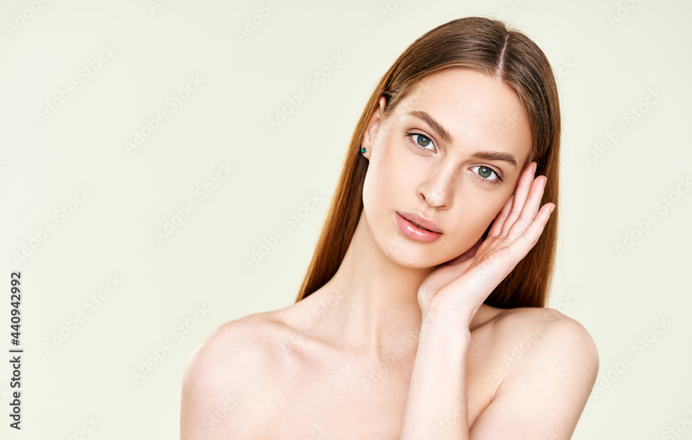 Close up portrait of beautiful young woman touching her face Close up portrait of beautiful young woman touching her face
