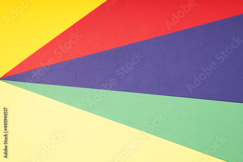multicolor paper background in red pruple green and yellow