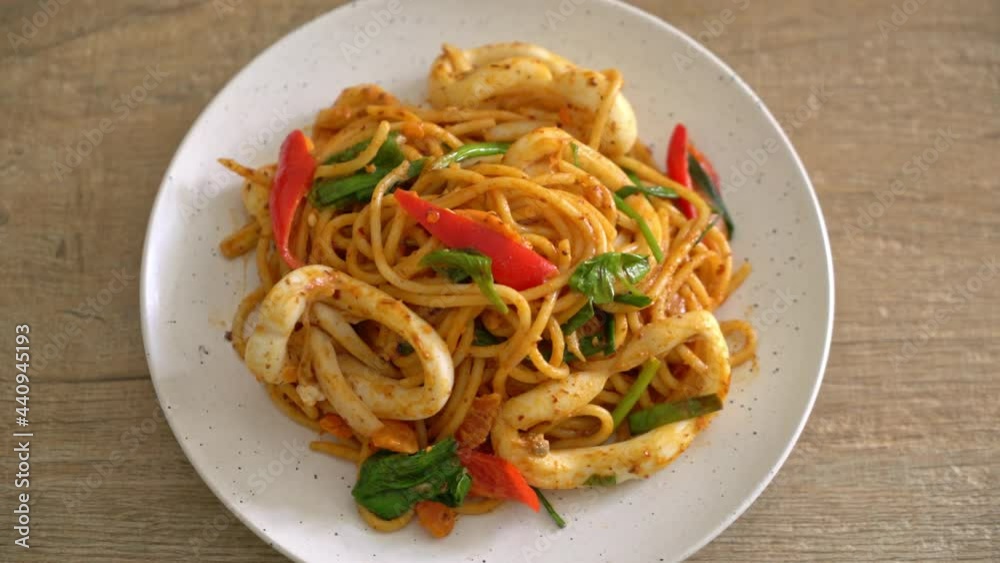 stir-fried spaghetti with salted egg and squid - fusion food style stir-fried spaghetti with salted egg and squid - fusion food style