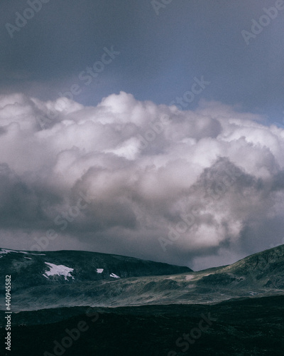 Complex and detailed clouds formations over glacier mountain top