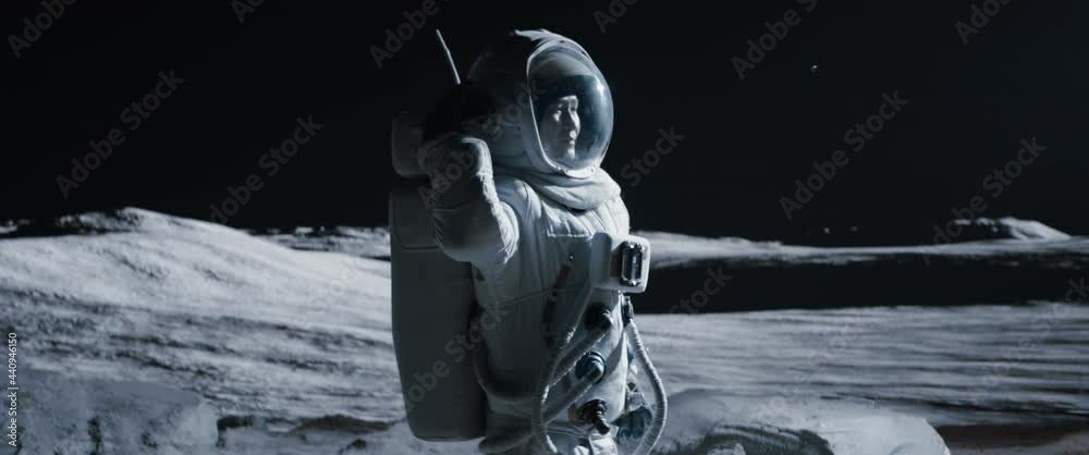 MID JIB Portrait of Asian lunar astronaut opens his visor while exploring Moon surface. Shot with 2x anamorphic lens