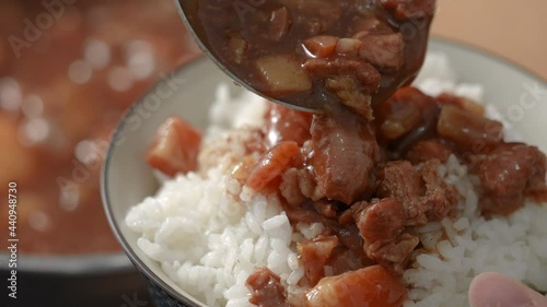 Pouring braised pork on cooked rice. Taiwanese traditional food. photo
