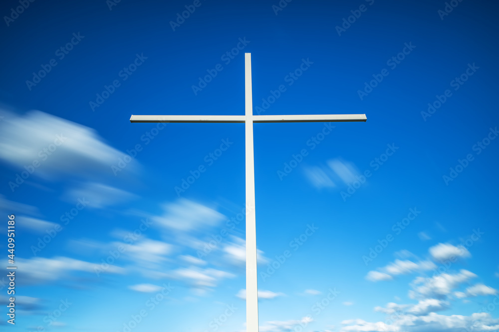 Christian cross against clouds, slow motion, long exposure