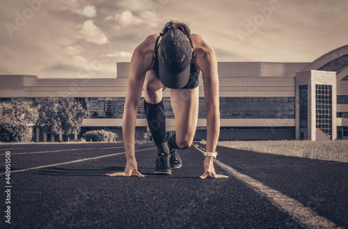 Image of a girl standing on the start line of the track. Running concept. photo