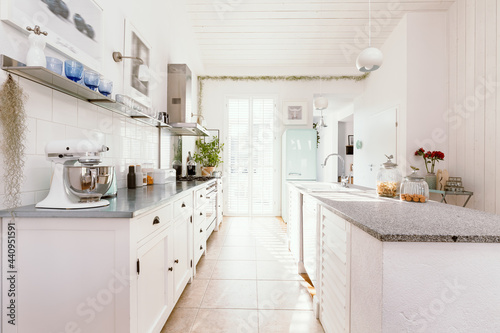Fototapeta Naklejka Na Ścianę i Meble -  Bright white open ln kitchen interior in stylish home for single family